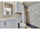 Well-lit bathroom featuring a tiled shower, sleek vanity, and ample storage space at 1809 Chinaberry Dr, Oldsmar, FL 34677