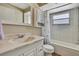 Well-lit bathroom featuring updated vanity and a shower-tub combo with bright white tile at 1809 Chinaberry Dr, Oldsmar, FL 34677