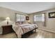 Bright bedroom with wood-look tile flooring and warm natural light from the window at 1809 Chinaberry Dr, Oldsmar, FL 34677
