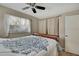Comfortable bedroom features wood-look tile floors and curtains to let the light filter in at 1809 Chinaberry Dr, Oldsmar, FL 34677