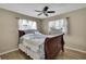 Inviting bedroom featuring modern ceiling fan and natural light shining through the windows at 1809 Chinaberry Dr, Oldsmar, FL 34677