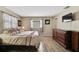 Comfortable bedroom featuring a serene ambiance and modern wood-look tile flooring at 1809 Chinaberry Dr, Oldsmar, FL 34677