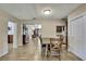 Open floor plan with dining room transitioning into the living room and hallways, showcasing wood floors at 1809 Chinaberry Dr, Oldsmar, FL 34677