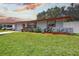 A well-kept single-story home with neat landscaping and a driveway leading to an attached garage at 1809 Chinaberry Dr, Oldsmar, FL 34677