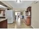 Hallway view with wood look tile that opens up to the living room and kitchen area at 1809 Chinaberry Dr, Oldsmar, FL 34677