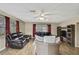 Spacious living room offers a ceiling fan, wood-look floors, entertainment center, and comfortable seating at 1809 Chinaberry Dr, Oldsmar, FL 34677