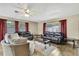 Bright living room boasts a ceiling fan, wood-look floors, and multiple seating areas at 1809 Chinaberry Dr, Oldsmar, FL 34677