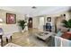 A well-decorated and comfortable living room with tile floors and a stylish furniture arrangement at 1809 Chinaberry Dr, Oldsmar, FL 34677
