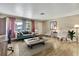 The living room offers wood-look tile, natural light, and neutral colored walls with stylish furnishings at 1809 Chinaberry Dr, Oldsmar, FL 34677