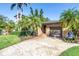 Inviting single-story home with lush tropical landscaping, and a patterned driveway at 200 Lamara Ne Way, St Petersburg, FL 33704