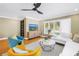 Inviting living room featuring hardwood floors, plantation shutters, comfortable seating, and a modern aesthetic at 200 Lamara Ne Way, St Petersburg, FL 33704