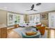 Bright living room with hardwood floors, plantation shutters, modern furniture, and contemporary decor at 200 Lamara Ne Way, St Petersburg, FL 33704