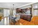 Open-concept living and dining area with hardwood floors, updated kitchen, and contemporary furnishings at 200 Lamara Ne Way, St Petersburg, FL 33704