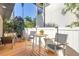 Cozy outdoor patio with comfortable seating, privacy fencing, and lush greenery, perfect for relaxing or entertaining at 200 Lamara Ne Way, St Petersburg, FL 33704