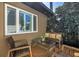 Relaxing outdoor patio with comfortable seating, a glass coffee table, and lush greenery at 200 Lamara Ne Way, St Petersburg, FL 33704