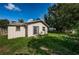 Expansive backyard featuring a sliding door entrance, and lush greenery at 2003 Whispering Pines St, Largo, FL 33774