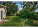 Backyard featuring grass and an abundance of greenery at 2003 Whispering Pines St, Largo, FL 33774