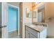Bathroom featuring granite counters, vanity, mirror and access to another room at 2003 Whispering Pines St, Largo, FL 33774