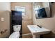 Bathroom featuring a pedestal sink, modern mirror, and toilet with storage shelving at 2003 Whispering Pines St, Largo, FL 33774