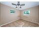 A standard bedroom with neutral walls, tile flooring and natural lighting from two windows at 2003 Whispering Pines St, Largo, FL 33774