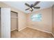 Bedroom with tan walls, tile flooring, closet and ceiling fan at 2003 Whispering Pines St, Largo, FL 33774