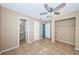 Bedroom with tile flooring, a ceiling fan, and a bathroom in view at 2003 Whispering Pines St, Largo, FL 33774