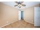 Bedroom featuring tile flooring, ceiling fan, door and a view to another room at 2003 Whispering Pines St, Largo, FL 33774