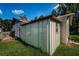 Exterior view of shed in backyard with tall grass around at 2003 Whispering Pines St, Largo, FL 33774