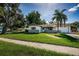Landscaped front yard leading up to a charming single story home with a one-car garage at 2003 Whispering Pines St, Largo, FL 33774