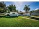 Charming single-story home featuring a well-maintained lawn and a beautiful palm tree at 2003 Whispering Pines St, Largo, FL 33774