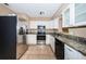 Well-equipped kitchen featuring stainless steel appliances and granite countertops at 2003 Whispering Pines St, Largo, FL 33774