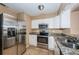 Kitchen with stainless steel appliances, granite countertops and tile flooring at 2003 Whispering Pines St, Largo, FL 33774
