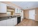 An eat-in kitchen area with white cabinets, granite countertops, stainless steel appliances, and tile flooring at 2003 Whispering Pines St, Largo, FL 33774