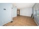 Spacious living room with light blue walls, white brick accent wall, and tile flooring at 2003 Whispering Pines St, Largo, FL 33774