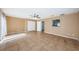 Large living room with tile flooring, a ceiling fan and view of kitchen through a window at 2003 Whispering Pines St, Largo, FL 33774