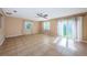 A bright living room featuring tile floors, ceiling fan and sliding door to the backyard at 2003 Whispering Pines St, Largo, FL 33774