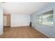 Bright living room with neutral tile floors and a painted brick accent wall at 2003 Whispering Pines St, Largo, FL 33774