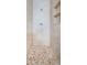 Tiled shower with mosaic tile floor and built-in shelving at 2003 Whispering Pines St, Largo, FL 33774