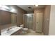 Well-lit bathroom with a single vanity, toilet, and a glass-enclosed shower at 205 Strong Bow Ct, Sun City Center, FL 33573