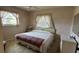 Comfortable bedroom with a bed, dresser, and window dressed with elegant curtains at 205 Strong Bow Ct, Sun City Center, FL 33573