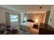 Bedroom featuring a ceiling fan, neutral walls, and a window offering natural light at 205 Strong Bow Ct, Sun City Center, FL 33573