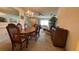 Spacious dining area open to the living room with chandelier and wood dining set at 205 Strong Bow Ct, Sun City Center, FL 33573