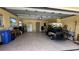 The garage shows ample space for parking and storage with a golf cart at 205 Strong Bow Ct, Sun City Center, FL 33573