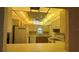 An eat-in kitchen shows a refrigerator, stove, and cabinets with a view into the living area at 205 Strong Bow Ct, Sun City Center, FL 33573