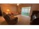 Cozy living room with sliding doors to screened lanai; featuring comfortable seating and carpet at 205 Strong Bow Ct, Sun City Center, FL 33573