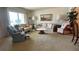 Bright living room with large windows, comfortable seating, and neutral-toned decor at 205 Strong Bow Ct, Sun City Center, FL 33573