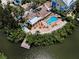 An aerial view of the community pool area shows nearby waterfront access with convenient boat dockage at 208 Haven Beach Ct, Indian Rocks Beach, FL 33785