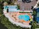 Aerial view of the outdoor community pool, with lounge chairs, parking, and easy access to the pool area at 208 Haven Beach Ct, Indian Rocks Beach, FL 33785