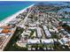 An aerial view shows the proximity of townhouses with boat docks on the canal and a walk to the beach at 208 Haven Beach Ct, Indian Rocks Beach, FL 33785