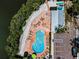 Aerial view of the outdoor pool showcasing lounge chairs and well manicured grounds, perfect for relaxation and community enjoyment at 208 Haven Beach Ct, Indian Rocks Beach, FL 33785